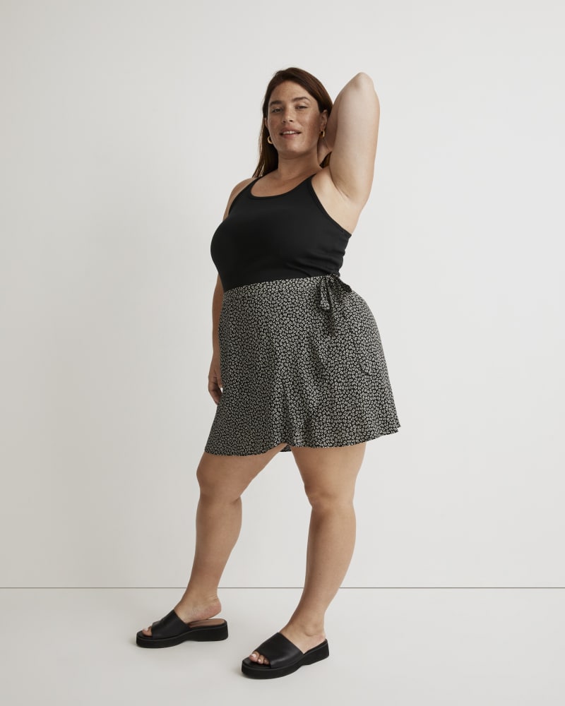 Front of a model wearing a size 20W True Wrap Mini Skirt in True Black by Madewell. | dia_product_style_image_id:327710